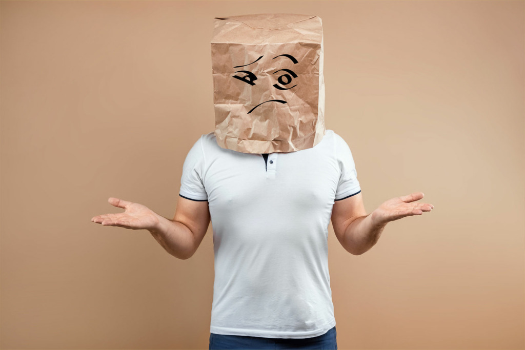 man put paper bag his head spreads his arms